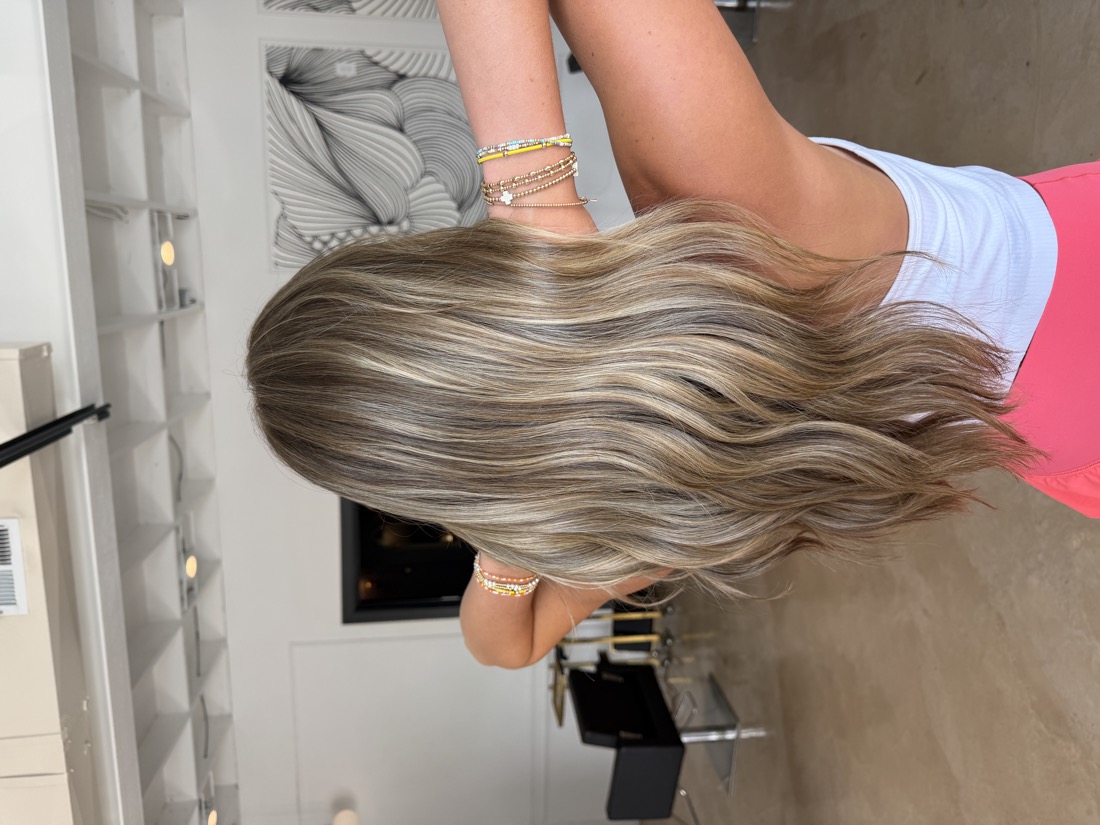 Dimensional blonde balayage with soft waves